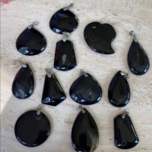 Polished black pendants by a rock collector.